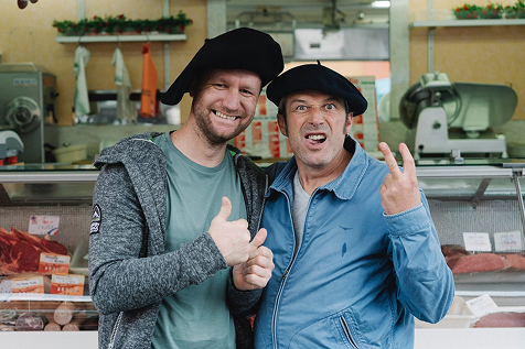 Two men smiling